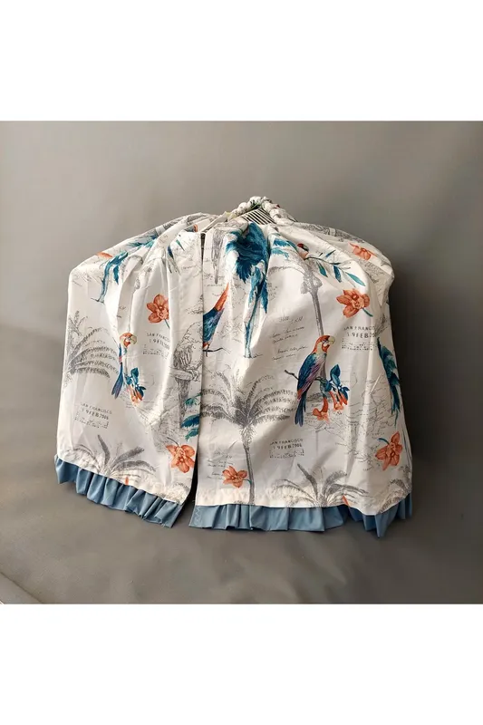 CAGE COVER WITH BIRD PATTERN AND INDIGO RUFFLE DETAILS ON AN ECRU GROUND
