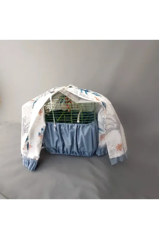 CAGE COVER WITH BIRD PATTERN AND INDIGO RUFFLE DETAILS ON AN ECRU GROUND