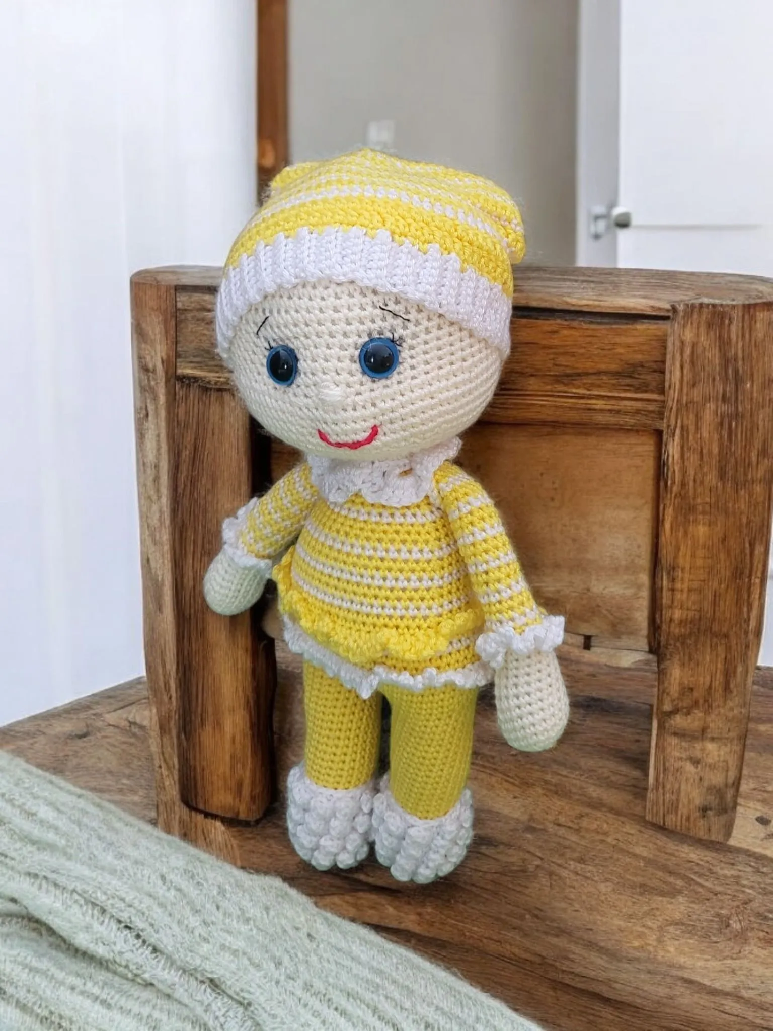 Baby in yellow pajamas with a pacifier