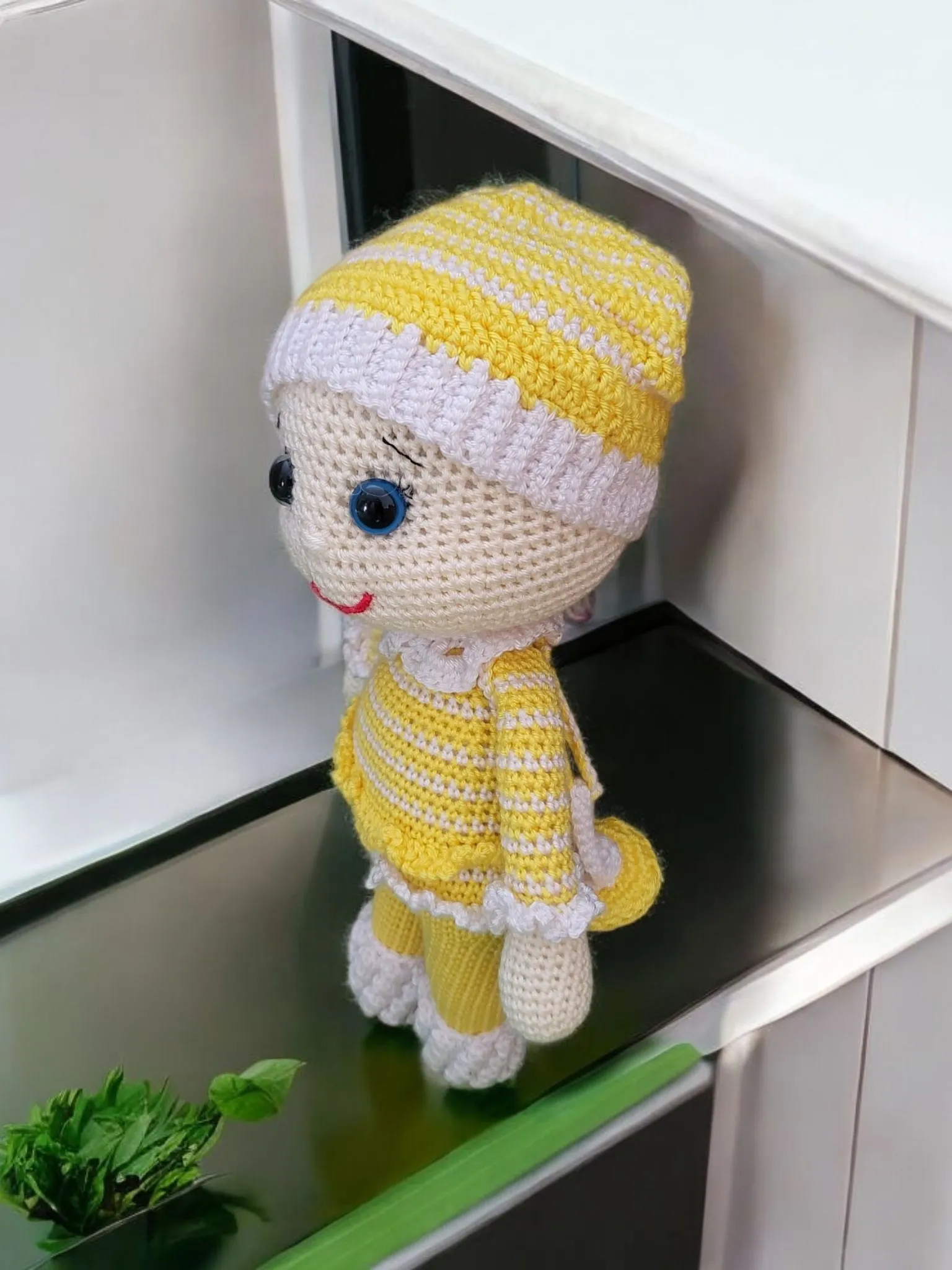 Baby in yellow pajamas with a pacifier
