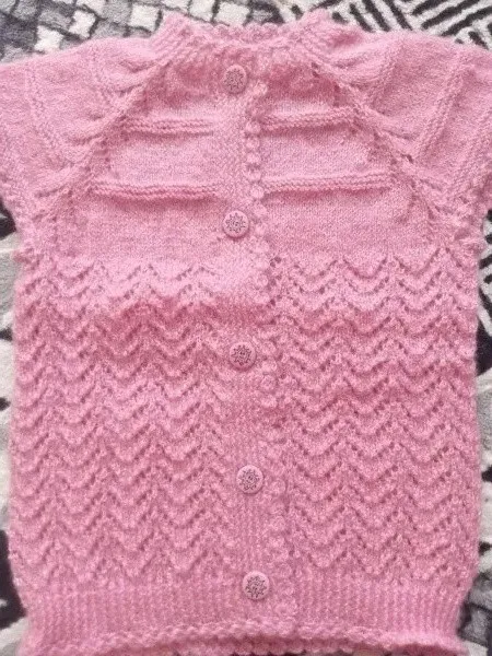 Hand Knitted Pink Baby Vest – Elegant and Stylish Design with Glittery Patterns