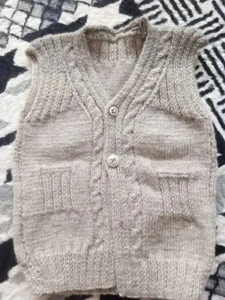 Gray Hand-Knitted Baby Vest – Stylish and Comfortable Model with Hair Braid Detail